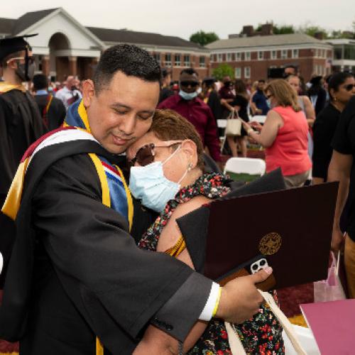 Iona grad Billy Falla embracing loved one at 2021 Commencement