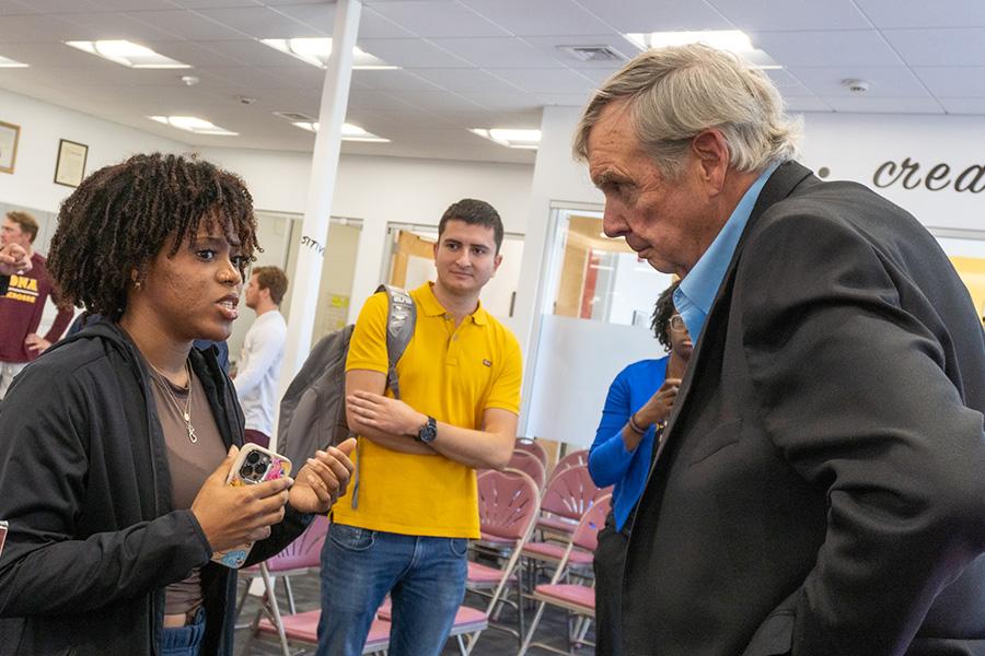 Jim Hynes speaks with a student